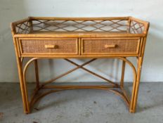 A glass topped whicker dressing table. Two drawers and galleried top AF (L 93cm x W 44cm x H 76cm)