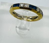 A sapphire and diamond eternity style ring in 18ct gold, approximate size L