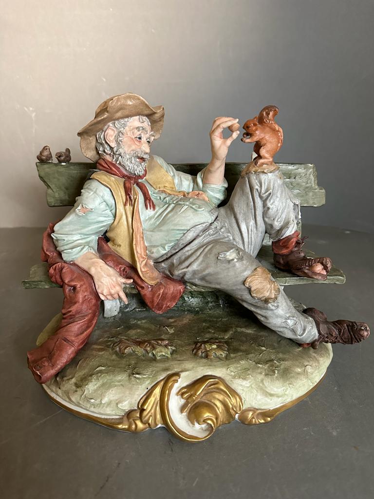 A selection of four Capodimonte figures to include Gentleman on benches, a man with a basket and a - Image 3 of 6
