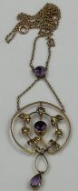 A 9ct gold pendant on fine chain with amethyst stones and seed pearls, approximate total weight 4.
