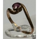 A 9ct gold fashion ring with single red stone, approximate total weight 1.4g.
