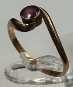 A 9ct gold fashion ring with single red stone, approximate total weight 1.4g.