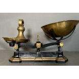 A set of vintage black cast iron and brass scales along with weights