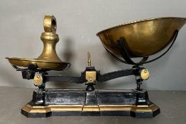 A set of vintage black cast iron and brass scales along with weights