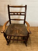 An oak and rustic style rush seat rocking chair