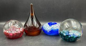 Four glass paperweights, three Caithness and a Selkirk glass