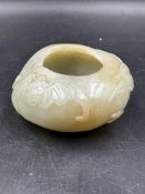 A Chinese jade bowl, approximate 7cm in diameter and 3cm high with floral decoration.