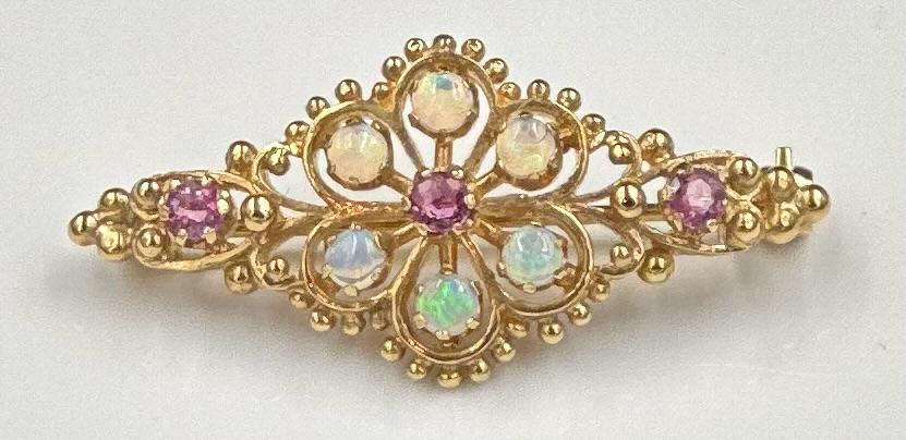 A beautiful opal and garnet brooch on 9ct yellow gold, approximate total weight 4.9g and 38mm in