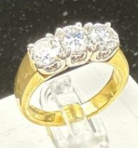 A three stone diamond ring, mounted in 18ct yellow and white gold, London hallmarked, EF maker,