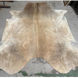 A cow hide rug or wall hanging 259 x 219