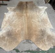 A cow hide rug or wall hanging 259 x 219