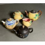 Three collectable teapots, one with matching jug and sugar bowl