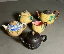 Three collectable teapots, one with matching jug and sugar bowl