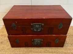 Two ornamental red Japanese suitcases