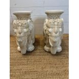 A pair of white ceramic elephant themed plant stands. H 44cm