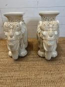 A pair of white ceramic elephant themed plant stands. H 44cm