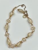 An Arabic gold bracelet with white stones, approximate total weight 8.4g