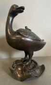 A Japanese bronze, Meiji period depicting a goose with frog on its back standing on a lotus leaf.