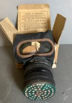 A WWII gas mask in original cardboard box