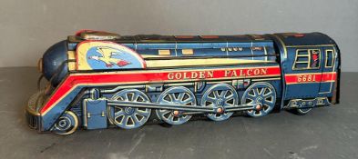 A vintage tin golden Falcon toy train