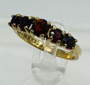 A 9ct gold, five stone garnet ring by S & K, approximate size L