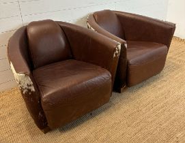 Two cow hide backed brown tub chairs
