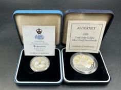 Two silver proof coins: 1997 Barbados 1$ and a 1999 Total Solar Eclipse Five Pounds