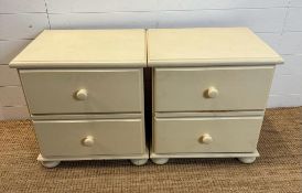 A pair of white painted two drawer bedside tables on bun feet (H53cm W51cm D43cm)