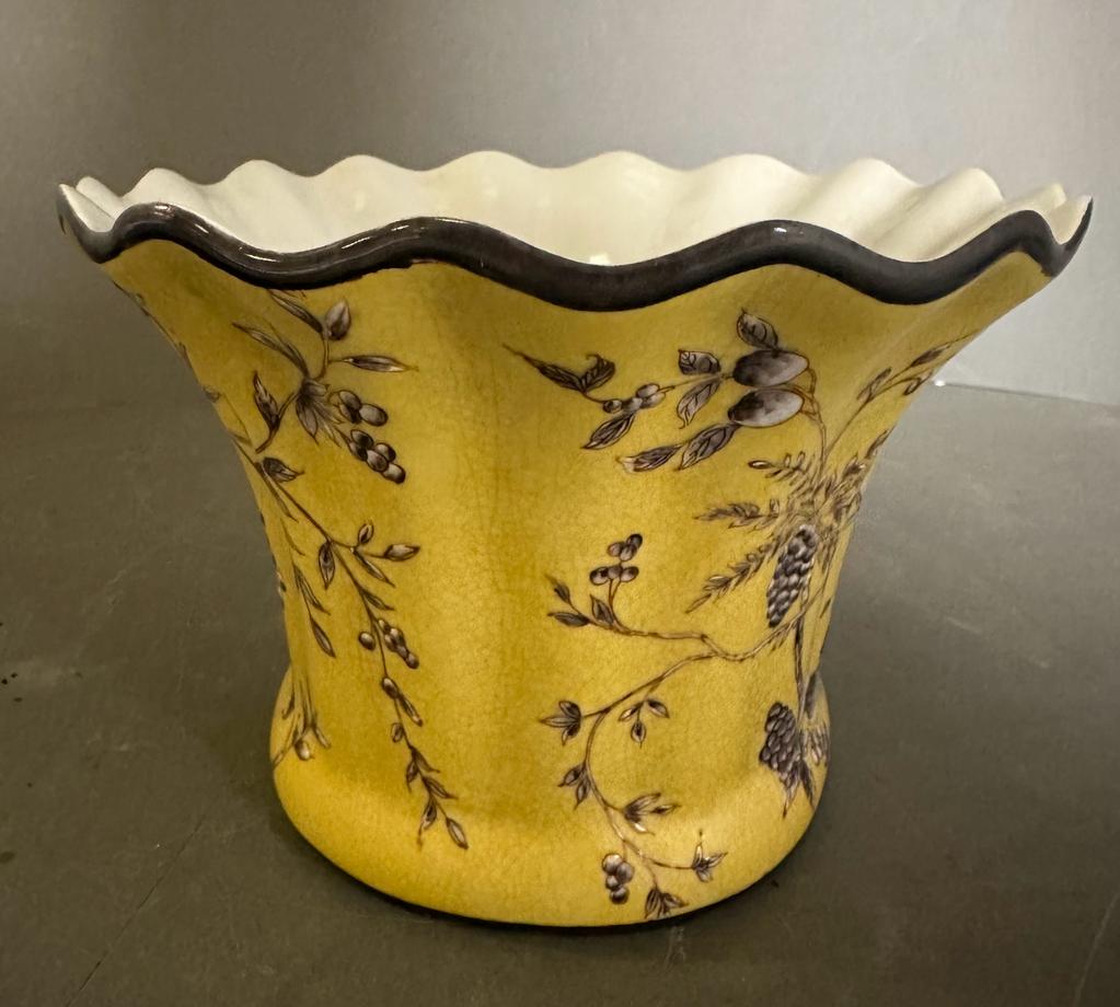 A yellow ground planter with a vine and olive pattern