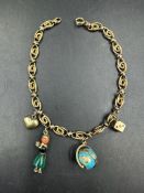 An Austrian gold charm bracelet in 14ct gold and with charms including a globe and a heart,