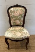 A mahogany framed Empire style chair with floral upholstery