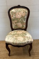 A mahogany framed Empire style chair with floral upholstery
