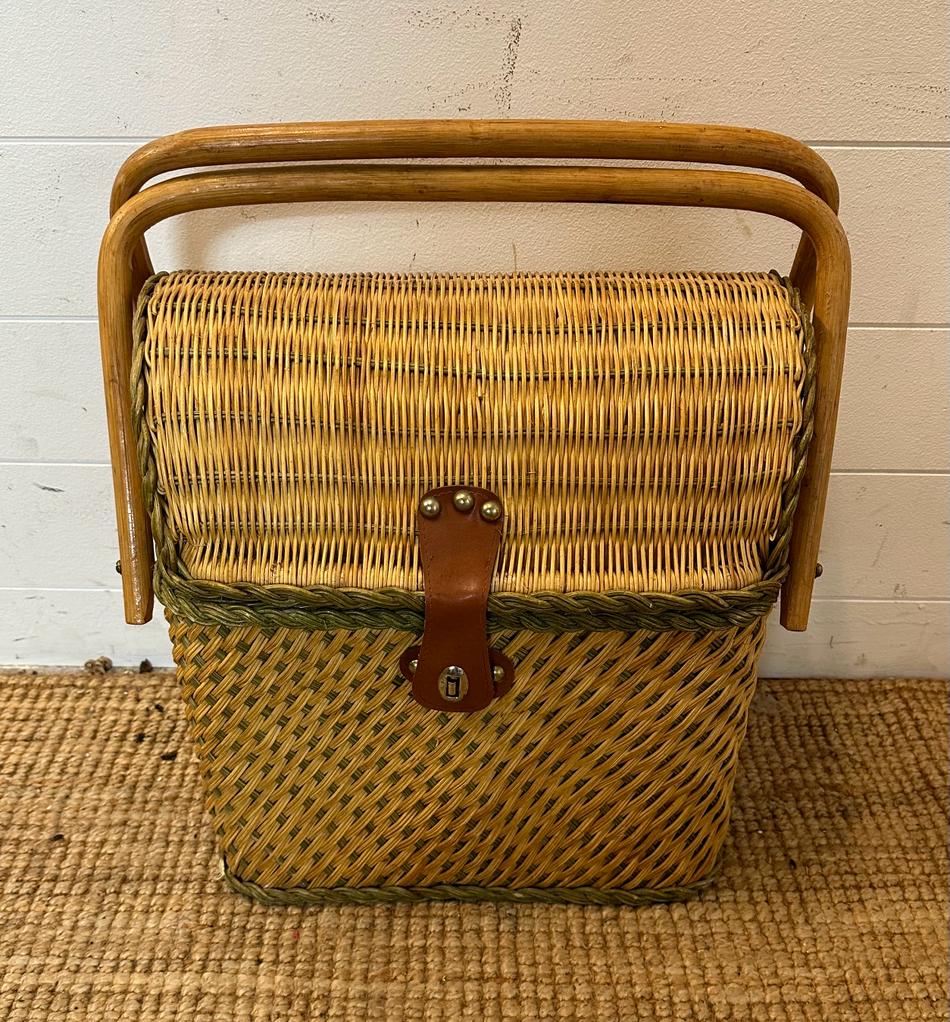 A vintage upright wicker picnic basket