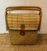 A vintage upright wicker picnic basket