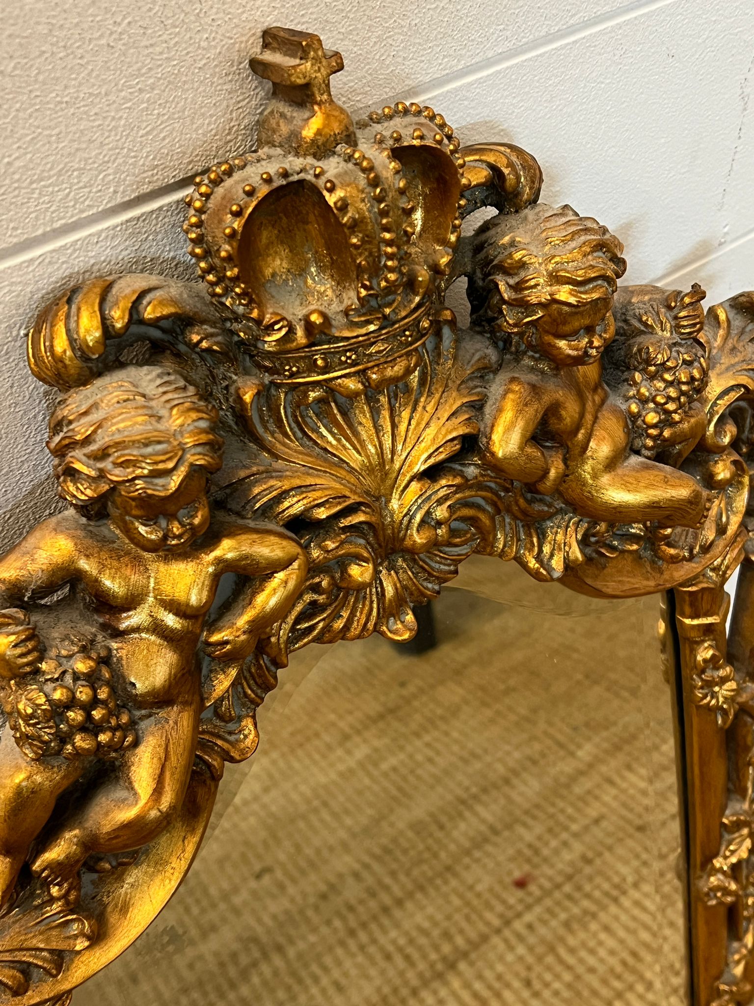 A gilt framed mirror with heavy carved cherubs 78cm x 48cm - Image 2 of 2
