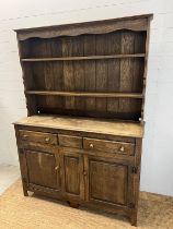 A rustic oak dresser, Plate rack sits on a base comprising of drawers and cupboards (H193cm W138cm