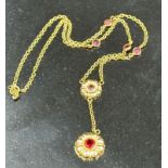 A 14ct gold necklace with garnet pendant and interspaced stones. Approximate total weight 4.5g.
