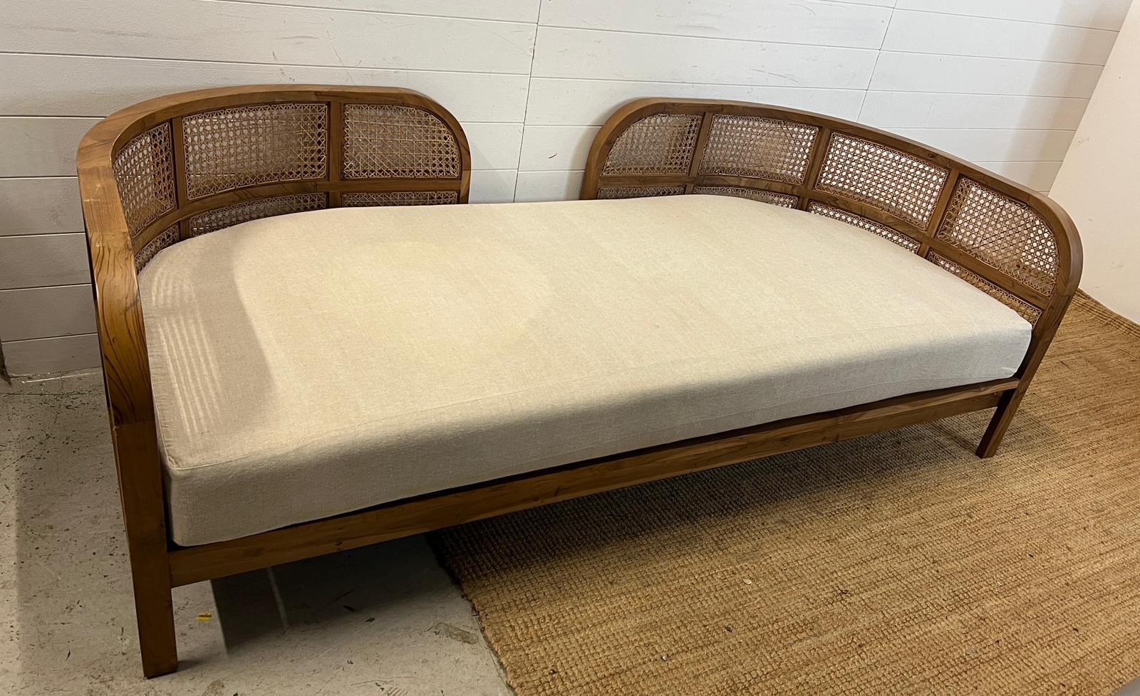 A Nest daybed with teak curved frame and cane sides (H69cm W212cm D98cm)