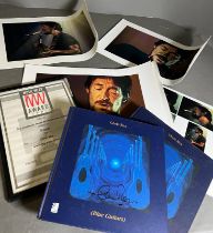 A selection of Chris Rea prints ,music award and signed Chris Rea (Blue Guitars) book plus one other