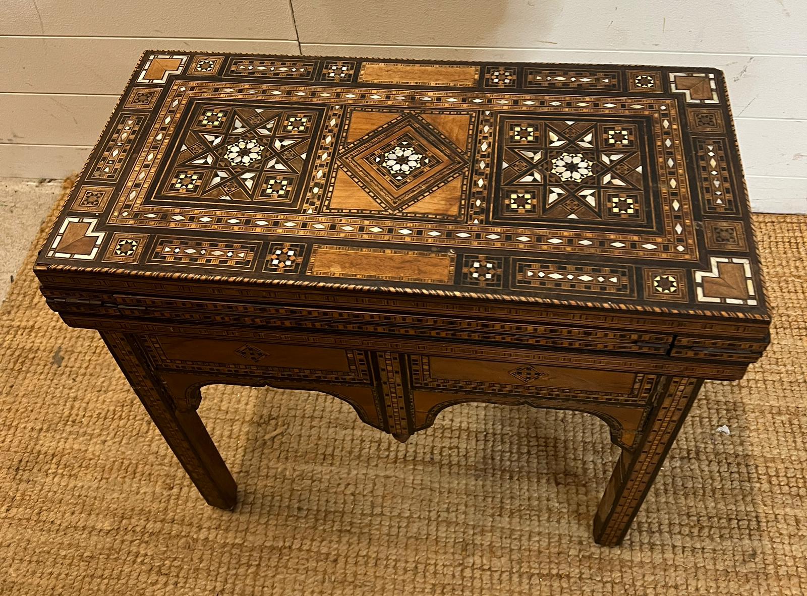 A marquetry inlaid games table with playing surface, back gammon, chess board etc , Damasais or - Image 2 of 9