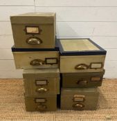 Seven vintage green storage boxes