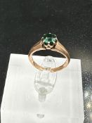 A gold ring with central emerald, approximate total weight 3.2g.
