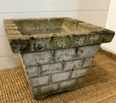 A square concrete garden planter with a brickwork design (H31cm W38cm D38cm)