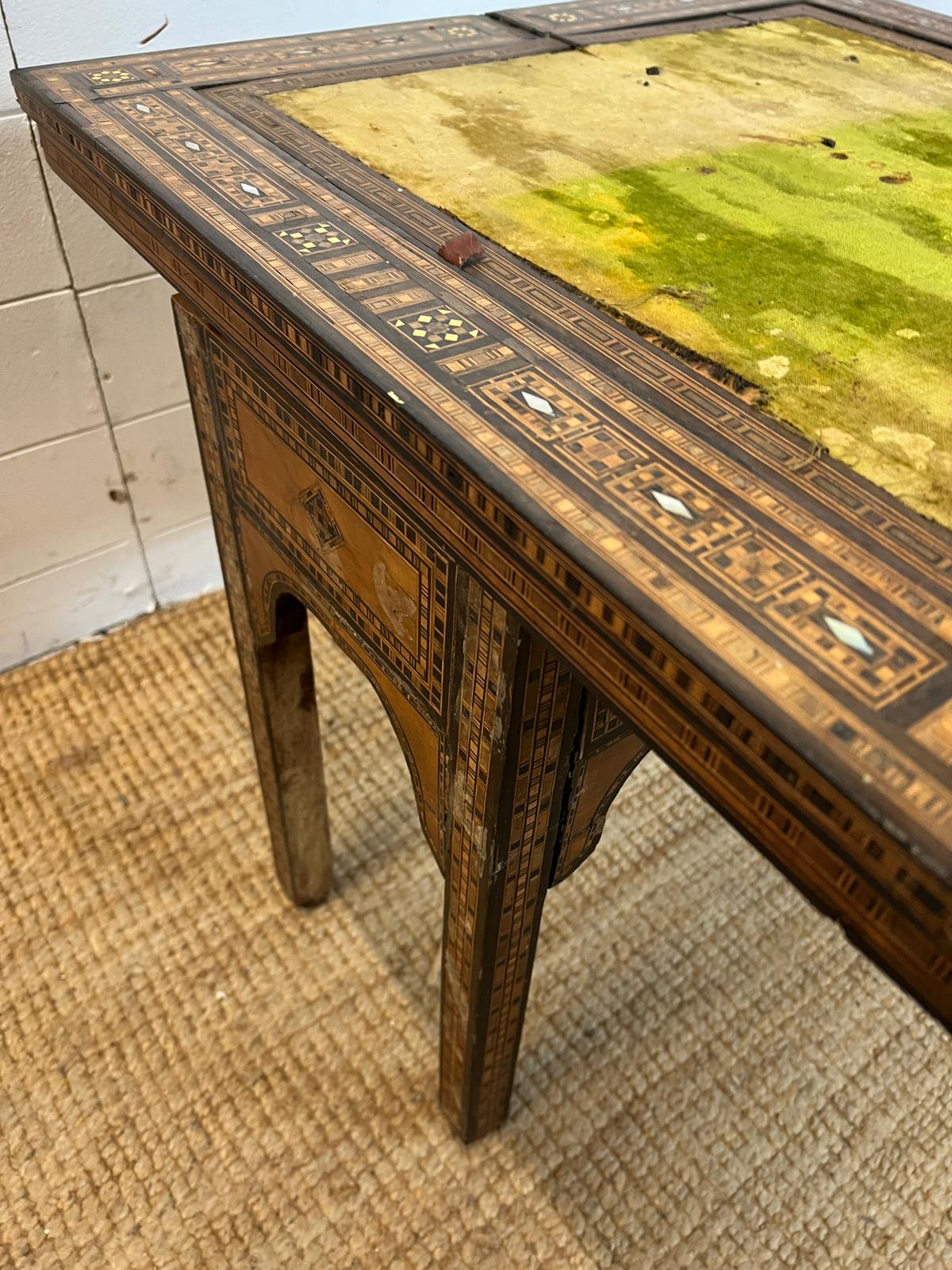 A marquetry inlaid games table with playing surface, back gammon, chess board etc , Damasais or - Image 4 of 9