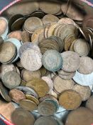 A biscuit tin with a variety of Great British coins, mainly copper various years denominations and