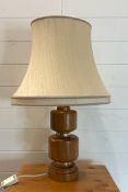 An oak turned table lamp with brass banding