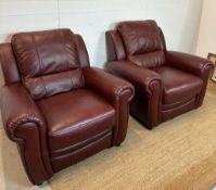 A red leather three piece suite comprising of two arm chairs and a two seater sofa