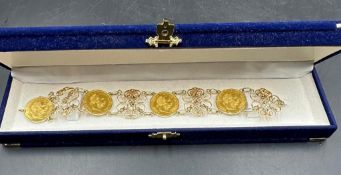A decorative filigree gold bracelet holding four 1915 Gold 1 ducat Austrian coins. Approximate total