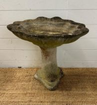 A concrete bird bath on a fish shaped base (H53cm Dia53cm)