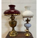 Two Victorian style table lamps on brass bases, one with cranberry glass shade and the other a white